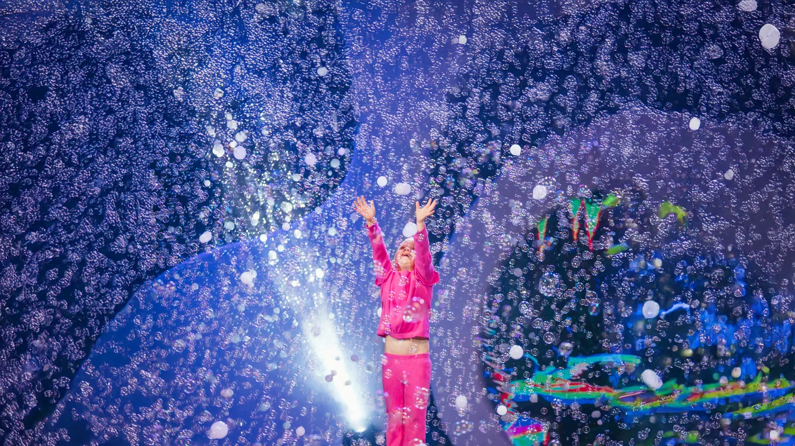 A storm of bubbles and confetti over the stage