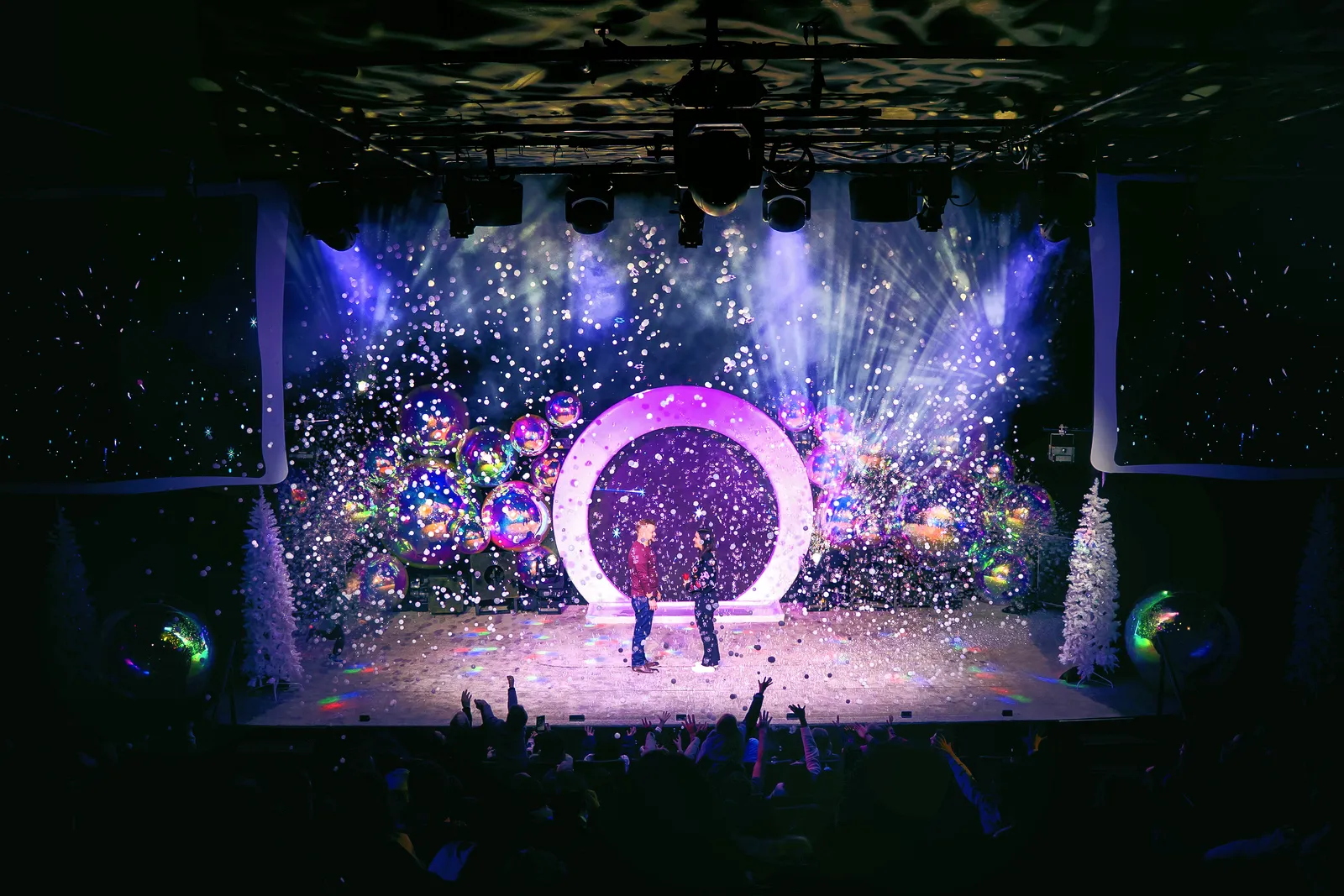 The holiday stage glowing under a shower of bubbles